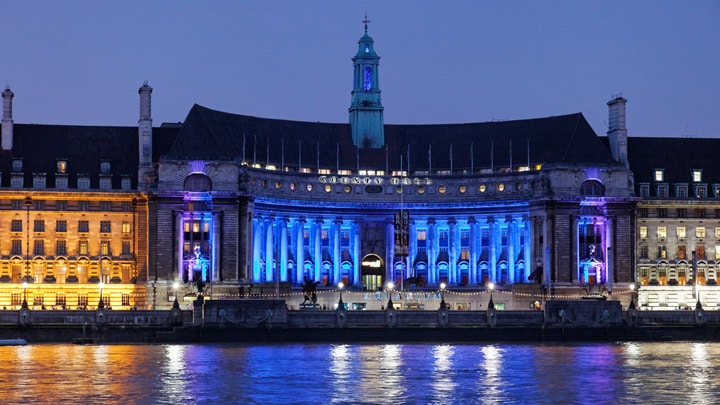 Modern building, brilliantly illuminated with red and blue façade lighting