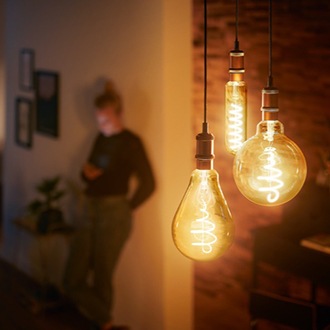 Des ampoules à DEL Philips de style rétro qui sont suspendues au plafond et dont les filaments détaillés sont visibles