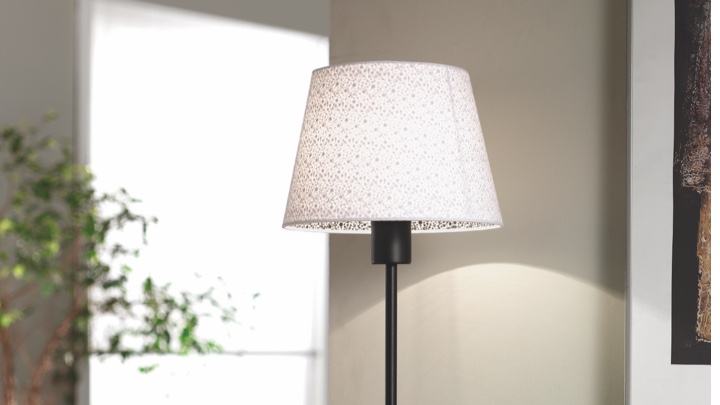 A table lamp on a desk in the hallway