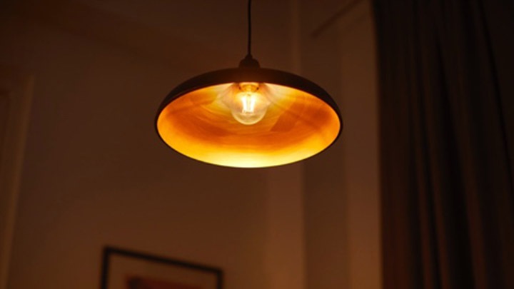 A lamp with a bulb that has a warm cozy glow