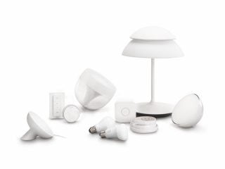 "Philips Hue smart LED lighting collection featuring table lamps, bulbs, and control devices for customizable home illumination and ambiance."
