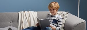 "Child reading under soft LED light, showcasing comfortable illumination for evening storytimes and promoting healthy sleep habits in cozy bedroom setting."